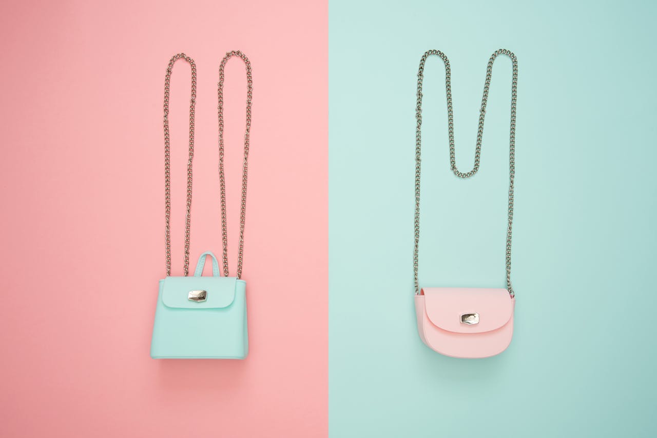 Stylish pastel handbags on pink and mint split backgrounds, perfect for fashion and design themes.